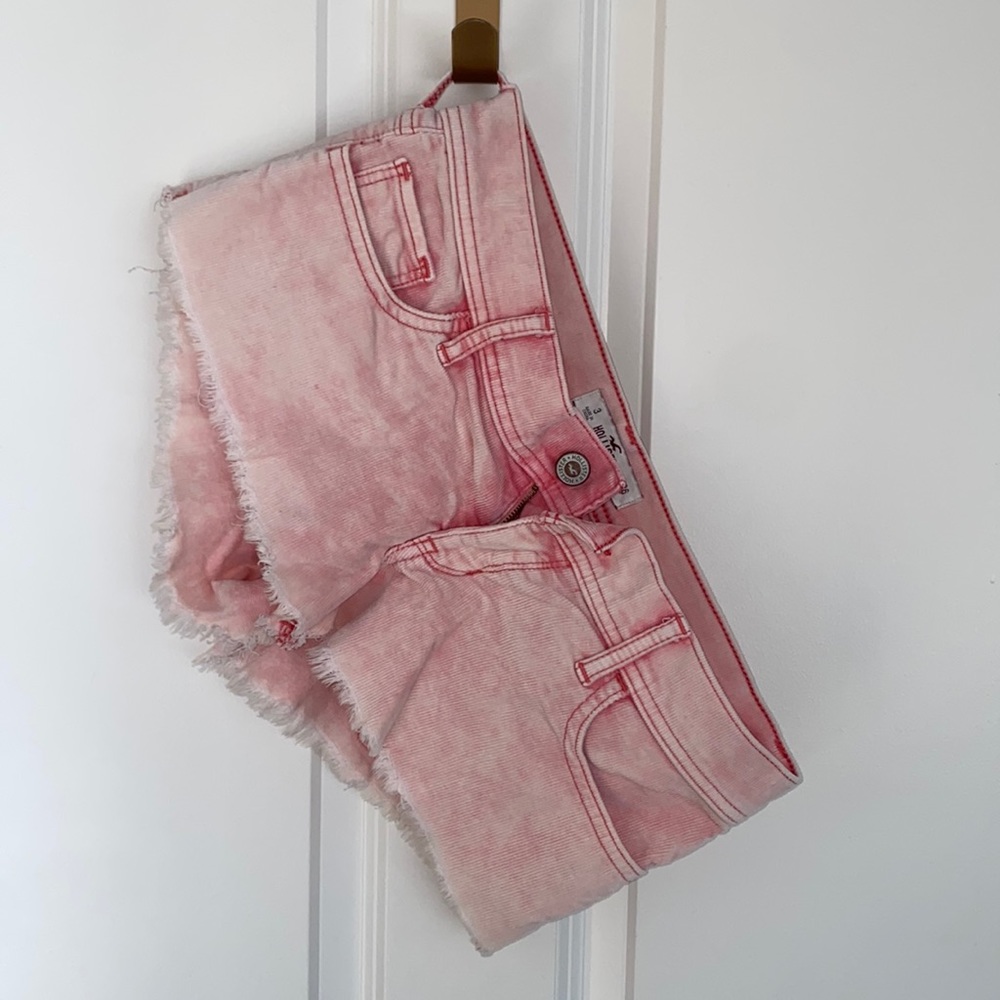 Pink low-rise distressed shorts